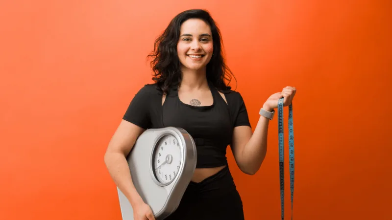 Fitserve client measuring body transformation progress with a coach