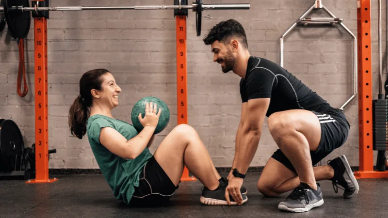 Certified Fitserve personal trainer coaching a client through a strength training session