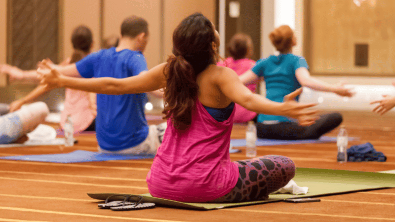 Corporate wellness group fitness class for employees led by a Fitserve trainer in an office